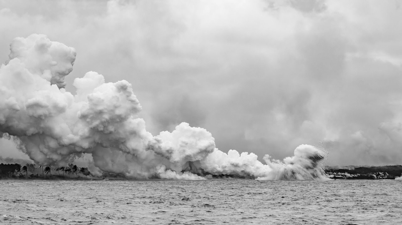Steam produced by molten lava pouring into the North Pacific Ocean.